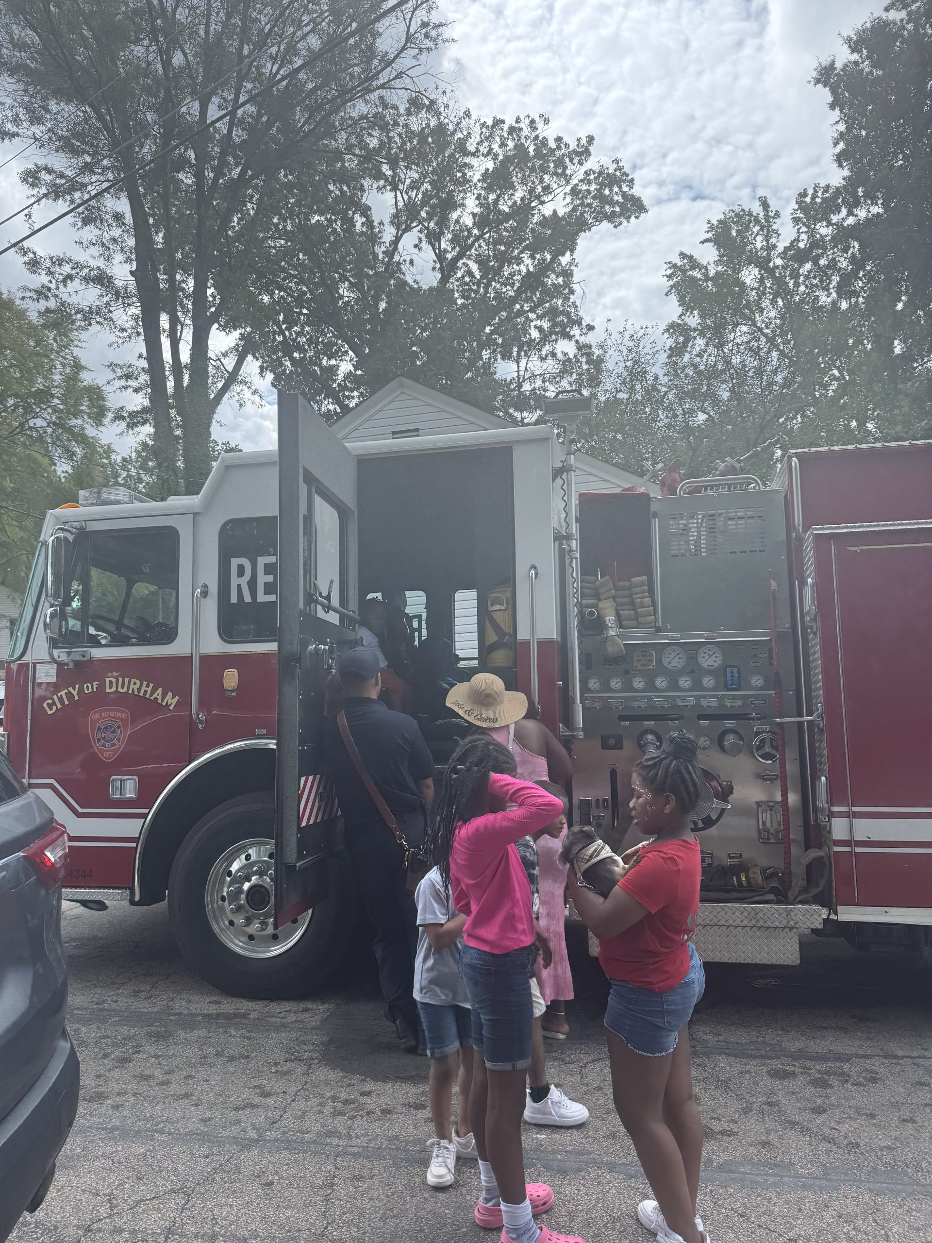 Children playing by a fire truck at a Breastfeed Durham community event