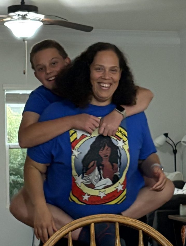 Love Anderson carrying her son on her back at a Lactation Collaborative gathering